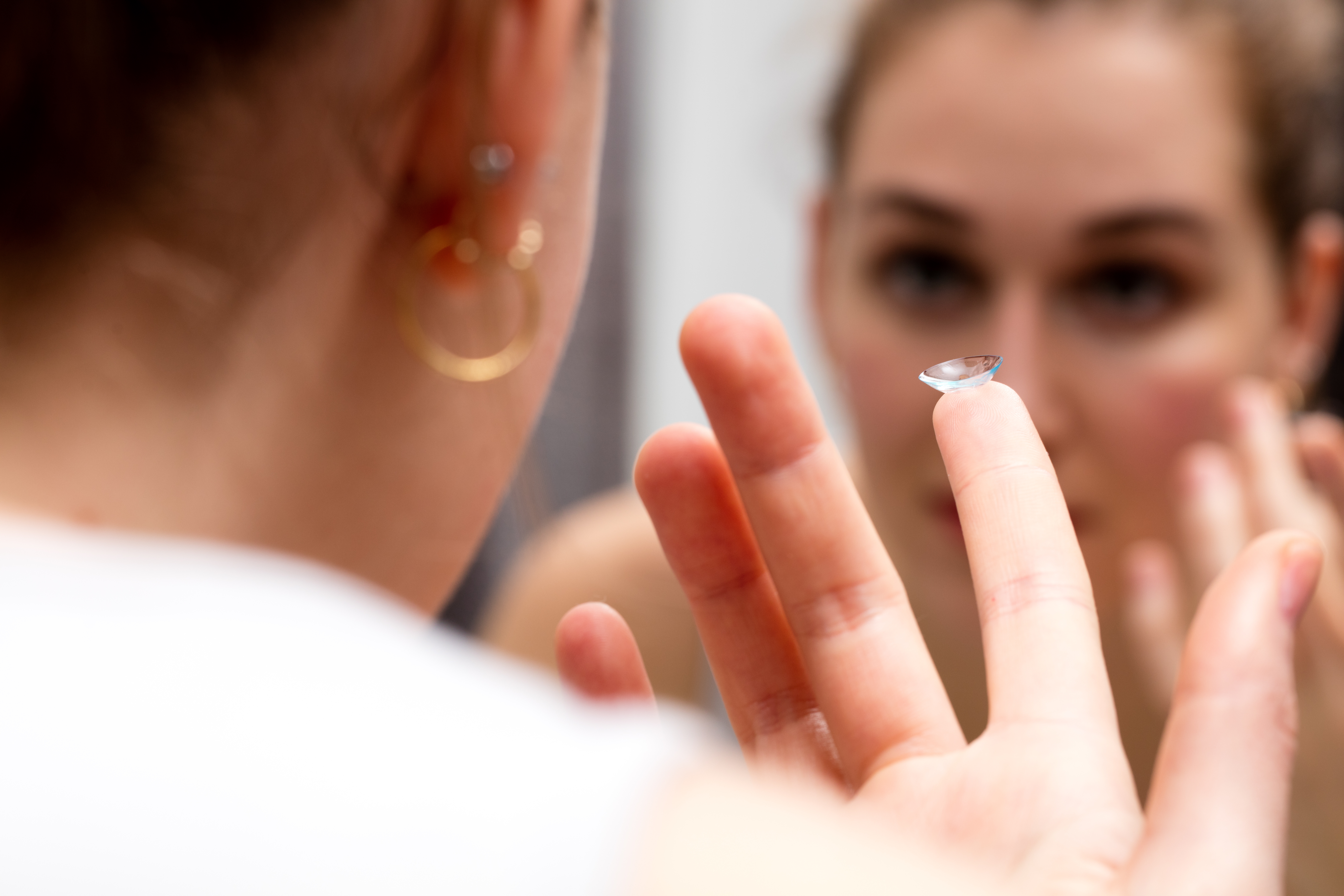 An Image of an Individual Putting In a Contact Lens