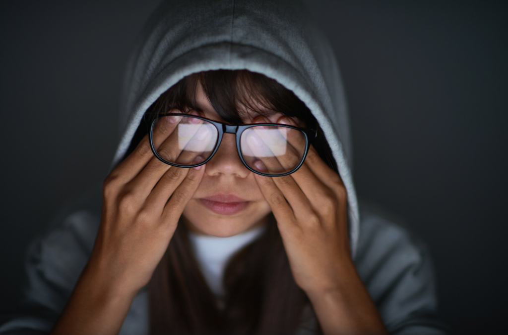 Image of Child with Glasses Rubbing Eyes