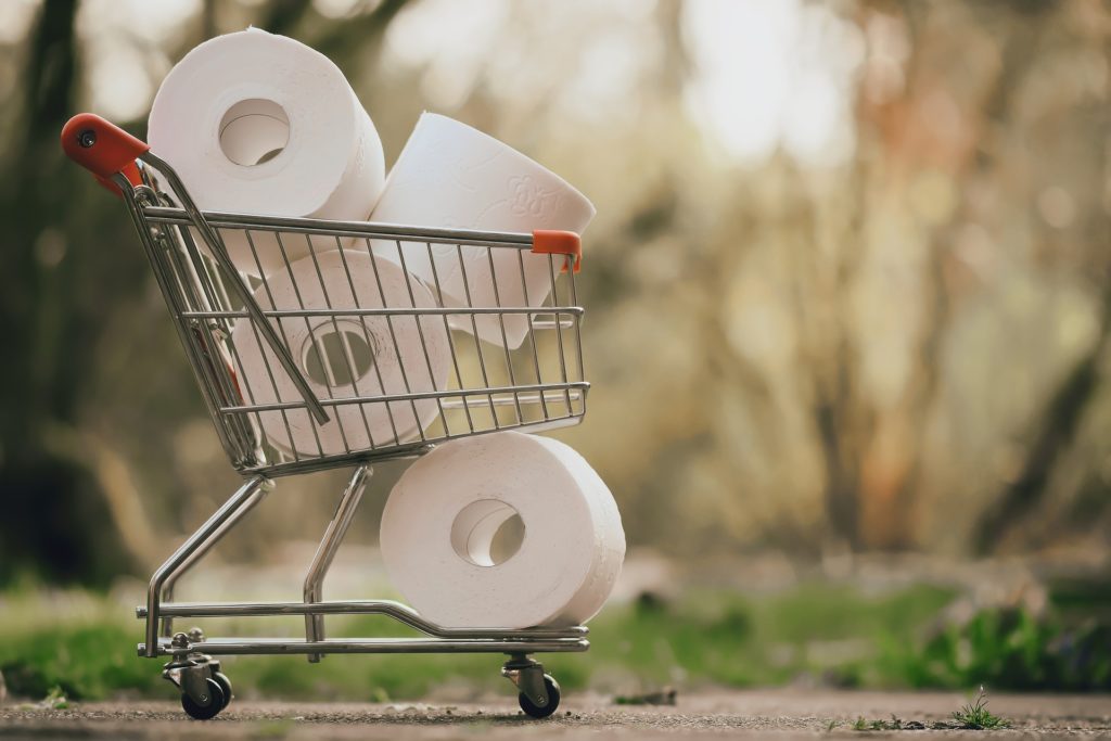 Miniature trolley filled with toilet paper rolls. 