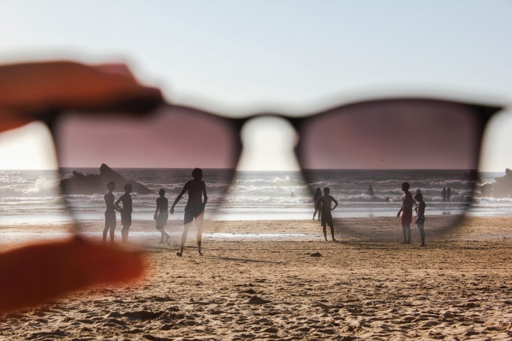 Looking through sunglasses at a beach scene