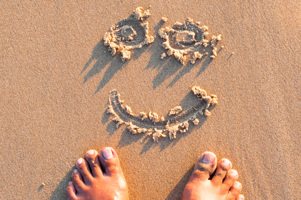 Smile drawn in sand