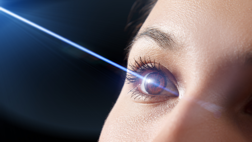 woman's eye with laser beam coming out