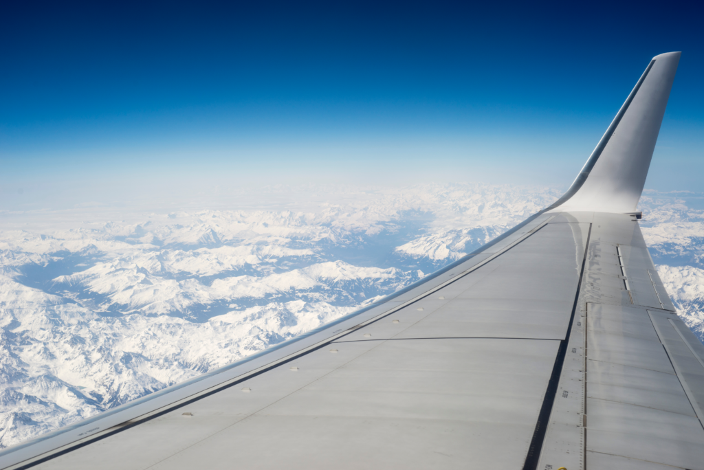 View of mountains over aeroplane wing